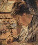 The Woman is sewing in front of the window
